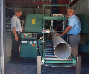 Energy Pipe & Supply employees cutting a custom piece of stainless steel pipe.